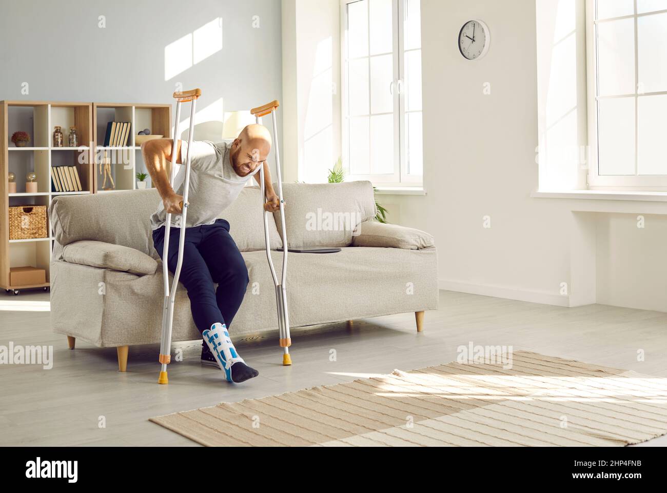 Man with leg injury feels pain and difficulty trying to get up from