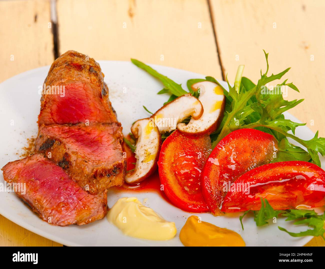 beef filet mignon grilled with fresh vegetables on side ,mushrooms
