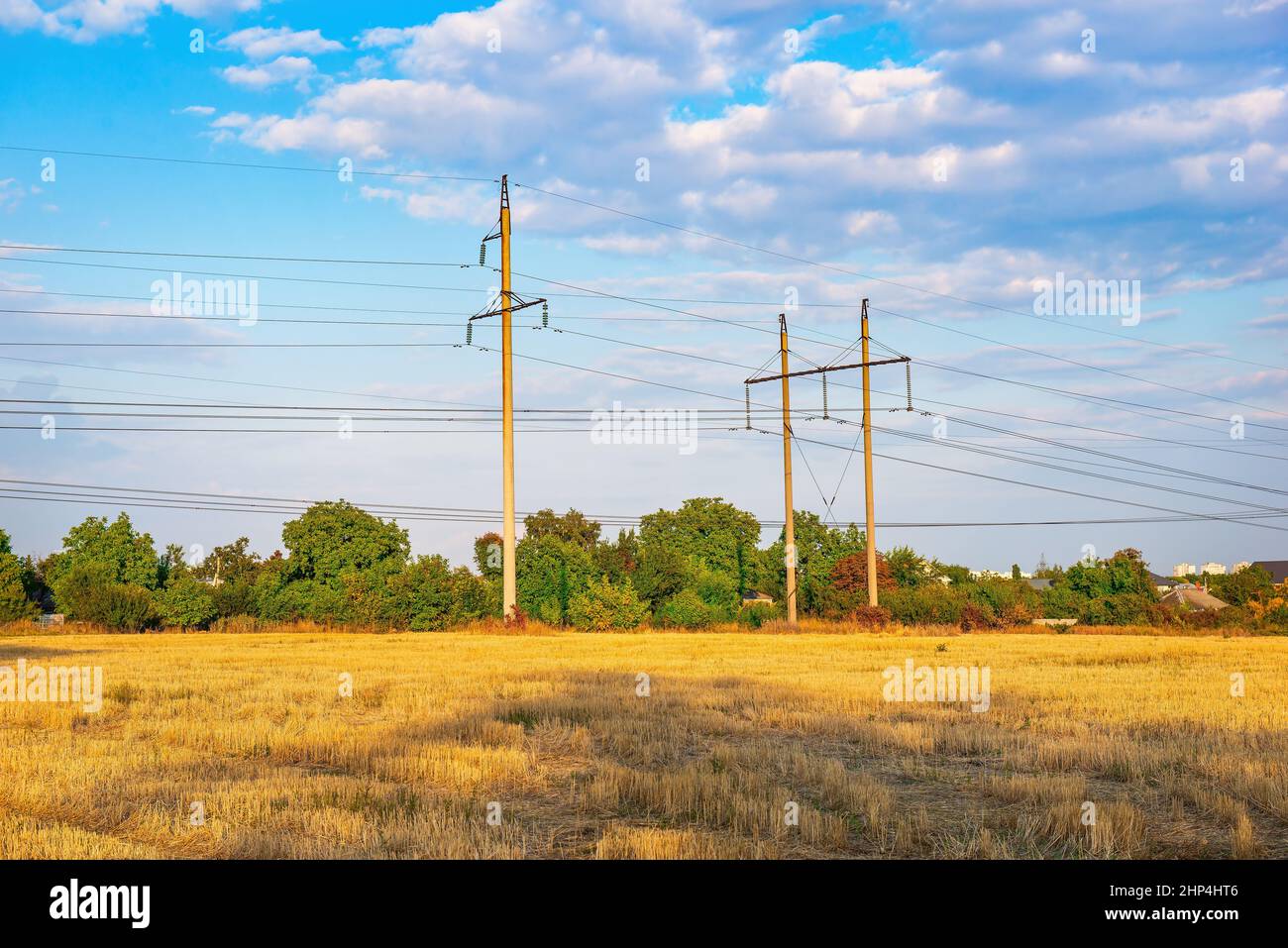 High electric poles on the field of mown wheat Stock Photo - Alamy