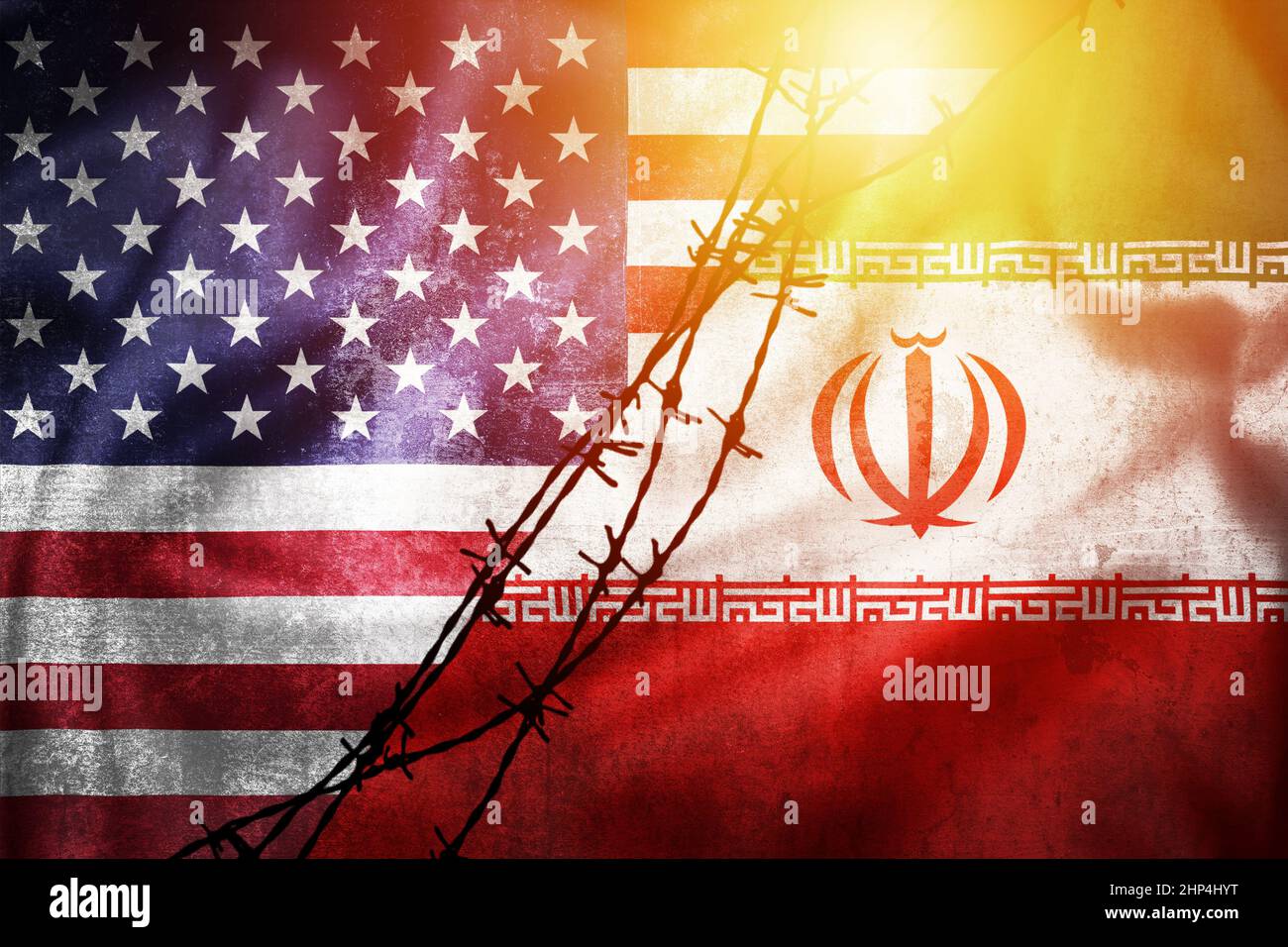 Grunge flags of Iran and USA divided by barb wire sun haze illustration, concept of tense relations between Iran and the USA Stock Photo