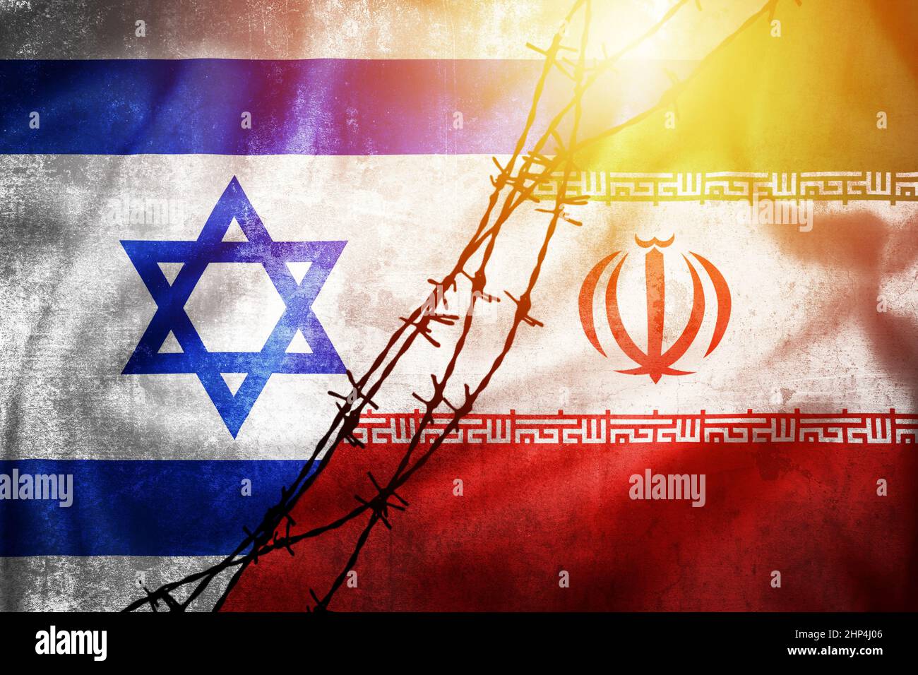 Grunge flags of Iran and Israel divided by barb wire sun haze illustration, concept of tense relations between Iran and Israel Stock Photo
