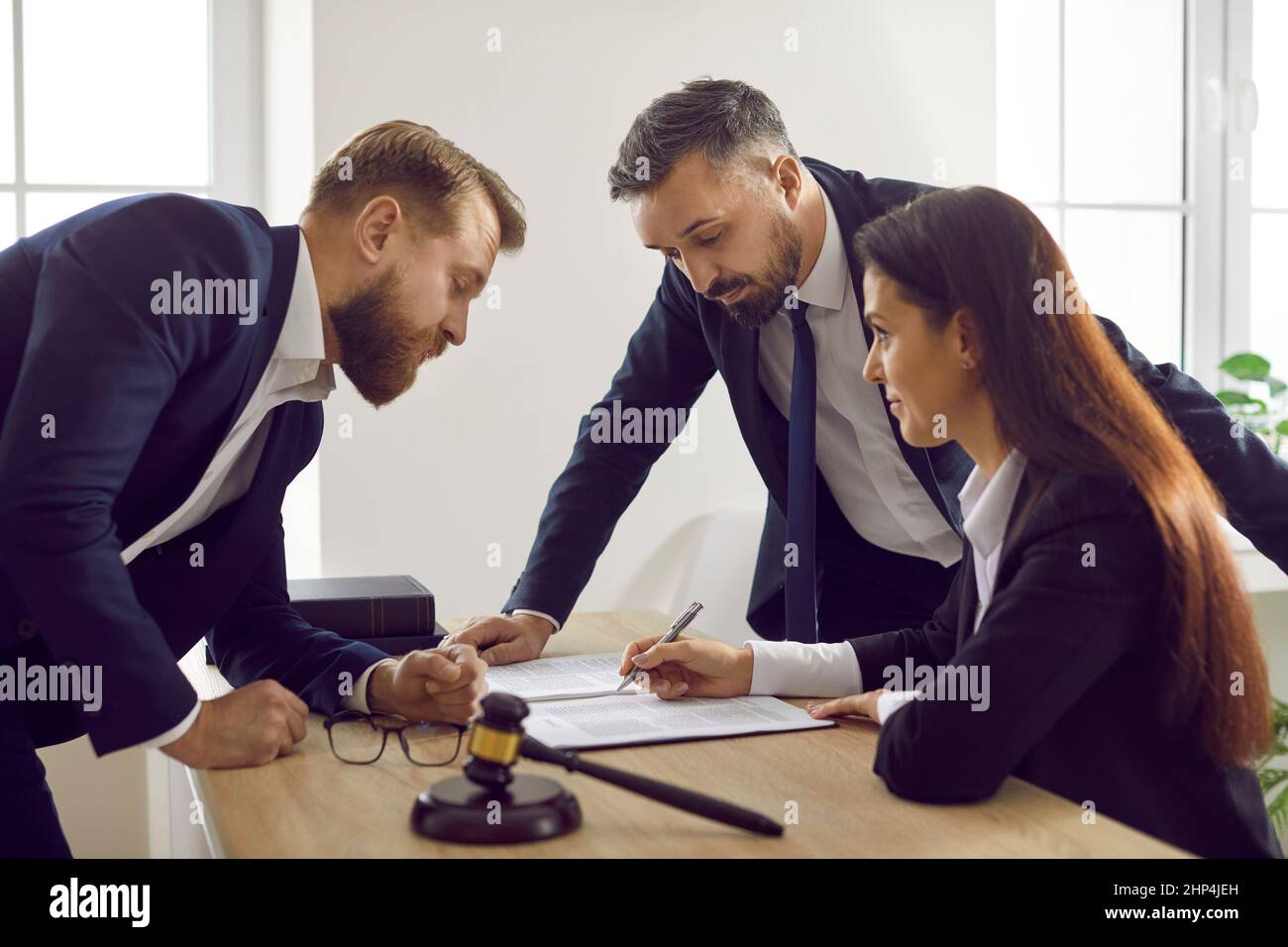 Group of lawyers meeting and working with court papers to ensure law and justice Stock Photo
