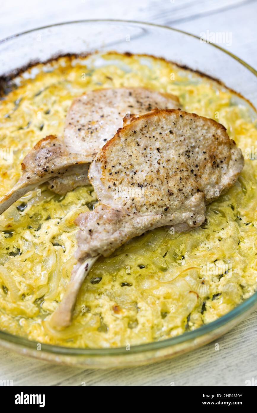seared pork chop roasted on creamy onion Stock Photo Alamy