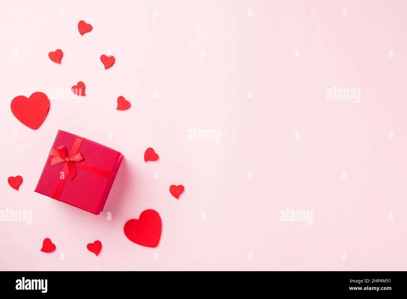 Valentines' day background. Red gift box with ribbon bow and wood red ...