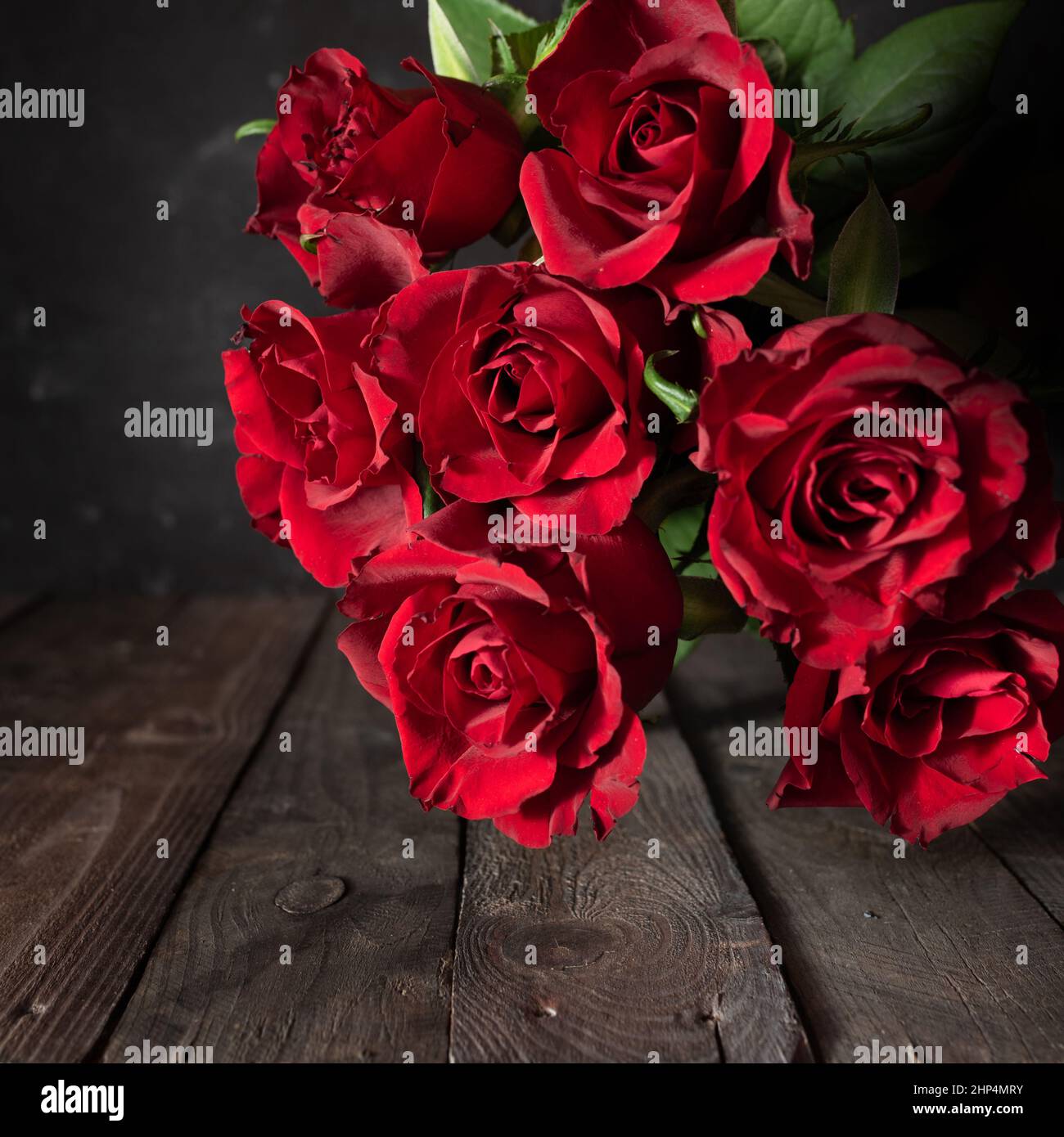 Bunch of red roses on dark vintage wood. Square background for ...