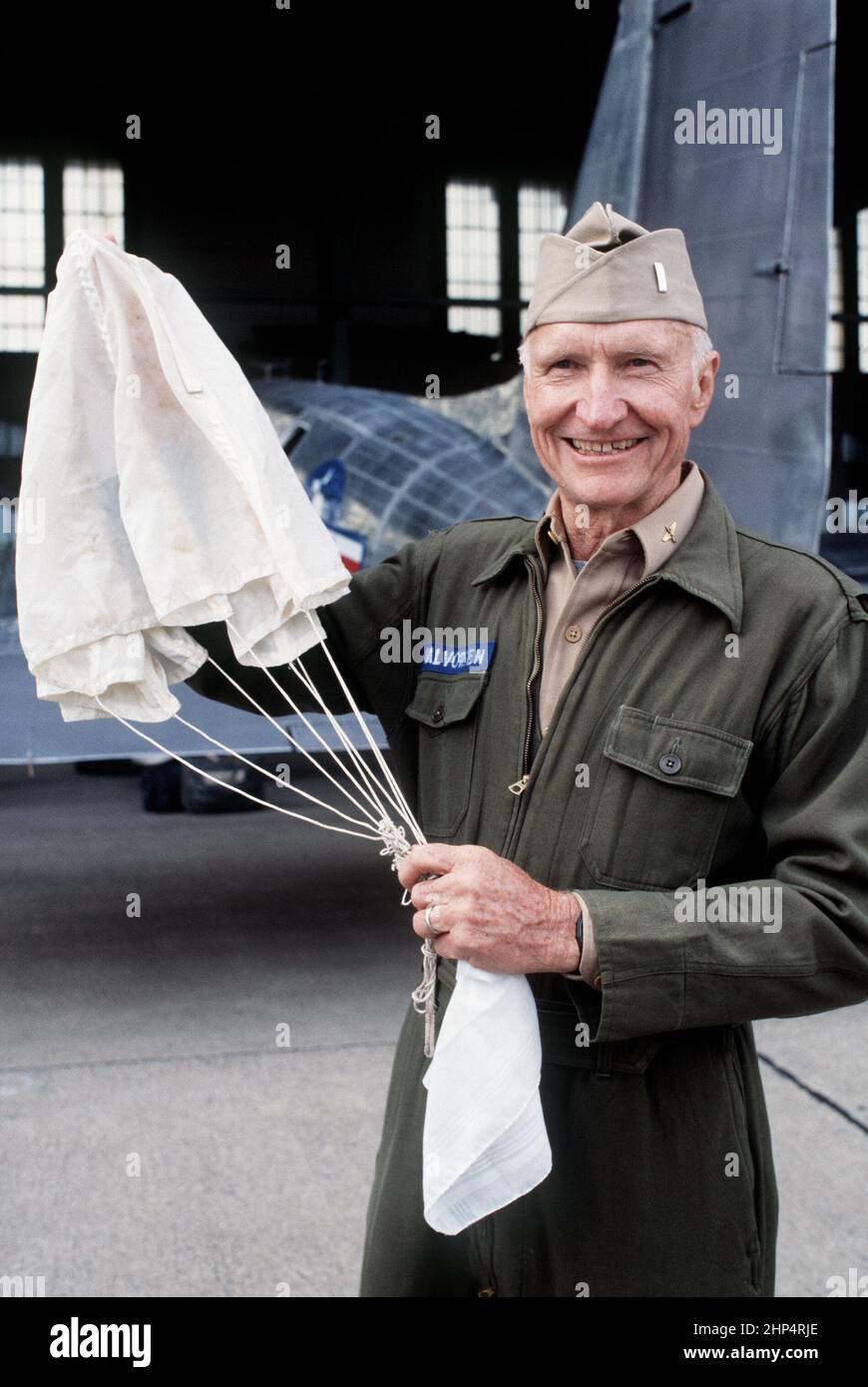 Retired COL Gail S. Halvorsen displays a parachute similar to the ones he used during the Berlin Airlift, when he acquired the nickname of the 'Rosinen (raisin) Bomber' for his practice of dropping candy to children who were lined up to watch aircraft landing at Tempelhof, West Berlin, 6/23/1988. Stock Photo