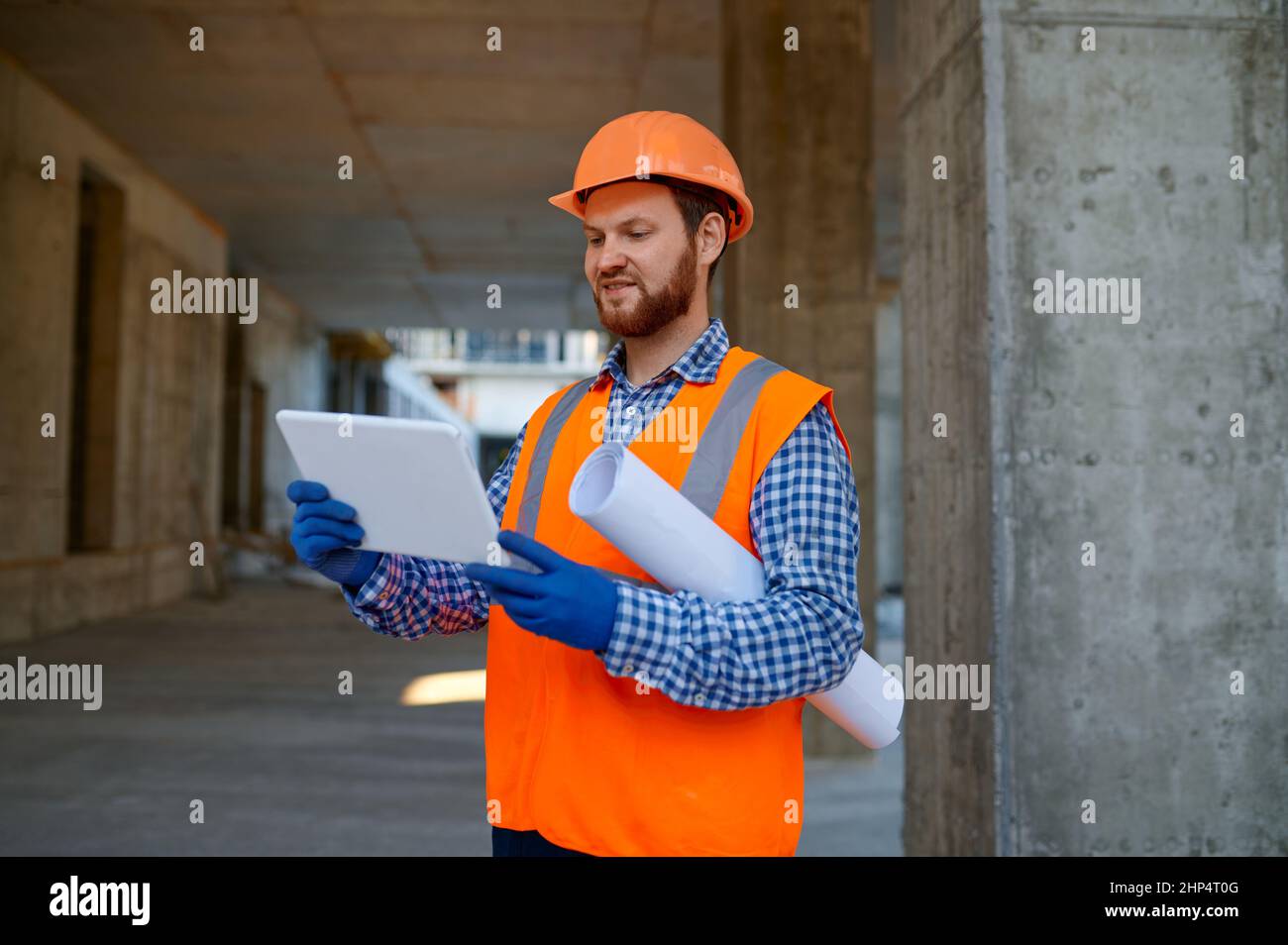 Contractor using digital tablet for connection with engineer. Builder reporting having video call Stock Photo