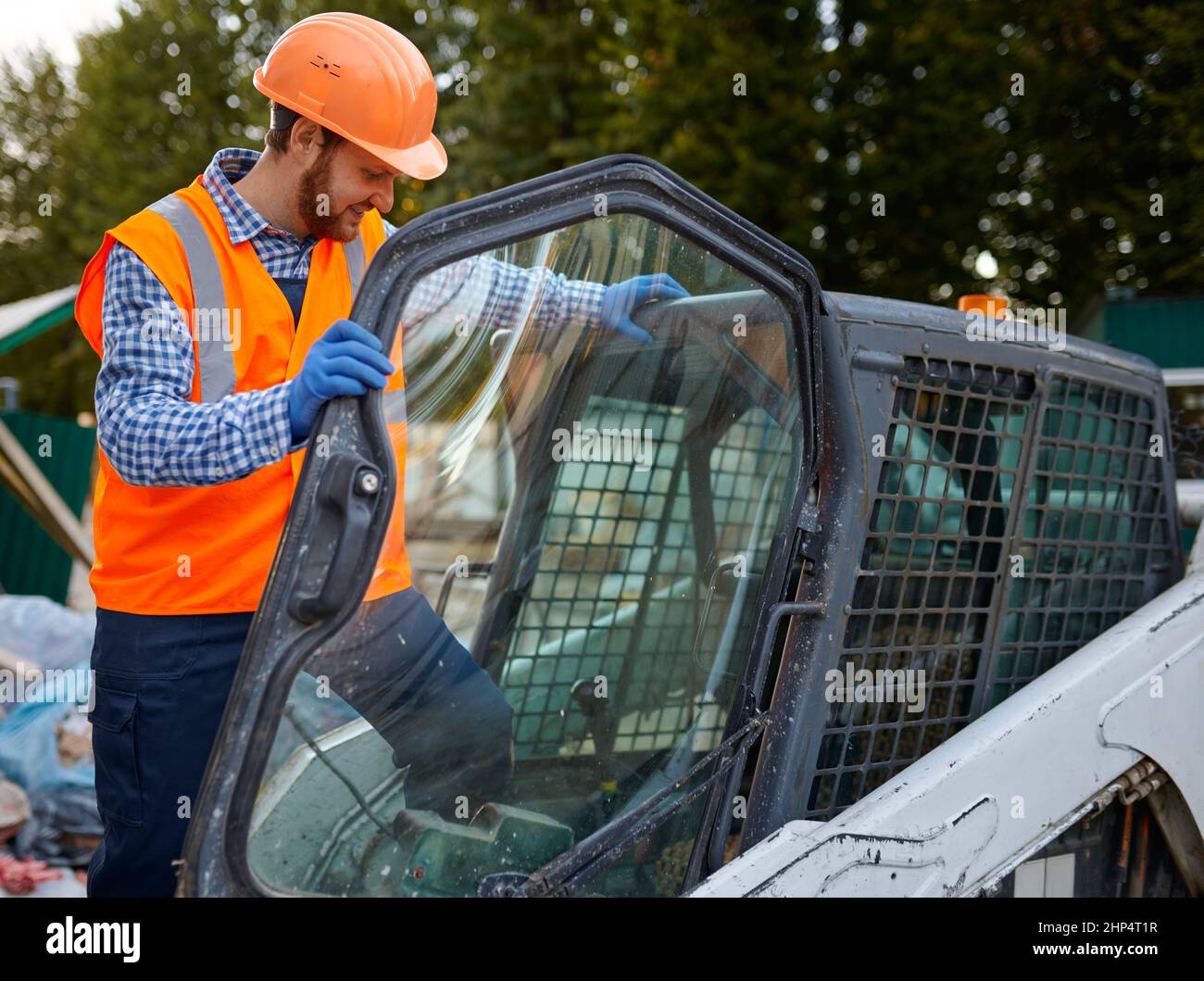 Smiling operator in skid steer cab, capturing that breakthrough moment of satisfaction Smiling operator in skid steer cab, capturing that breakthrough moment of satisfaction