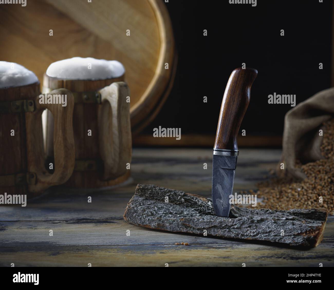 small knife with a burl handle is stuck in a piece of wood and stands