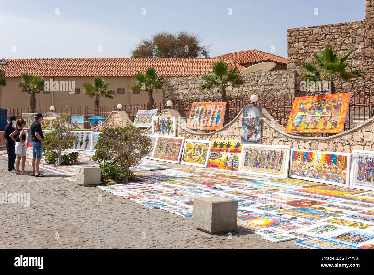 Local paintings for sale on pedestrianised seafront street, Rua Kuamen