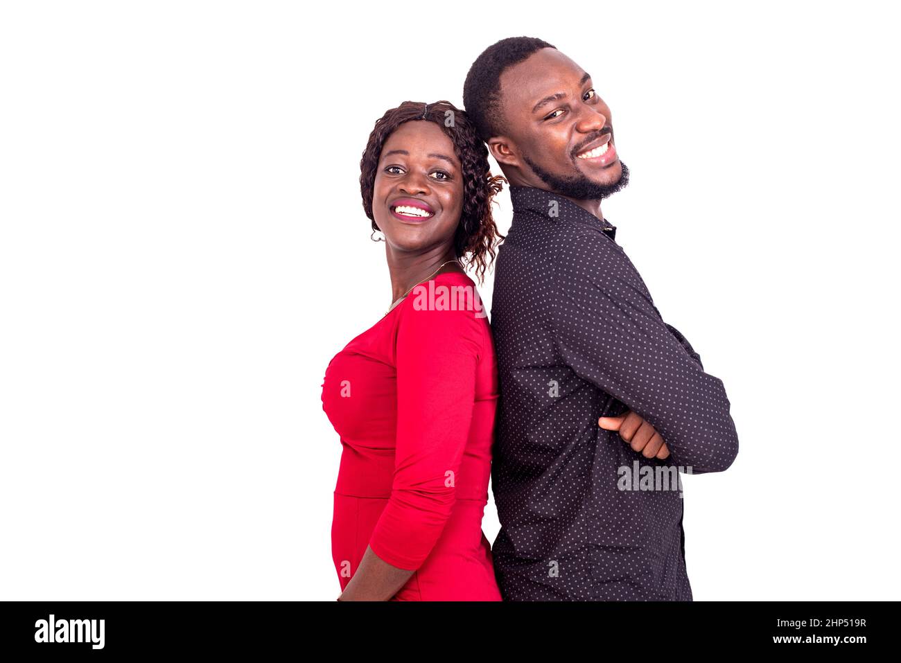 young african couple standing on white background back to back and ...