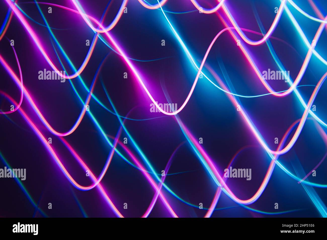 Neon blue and pink led lines on a dark night background. Kaleidoscope