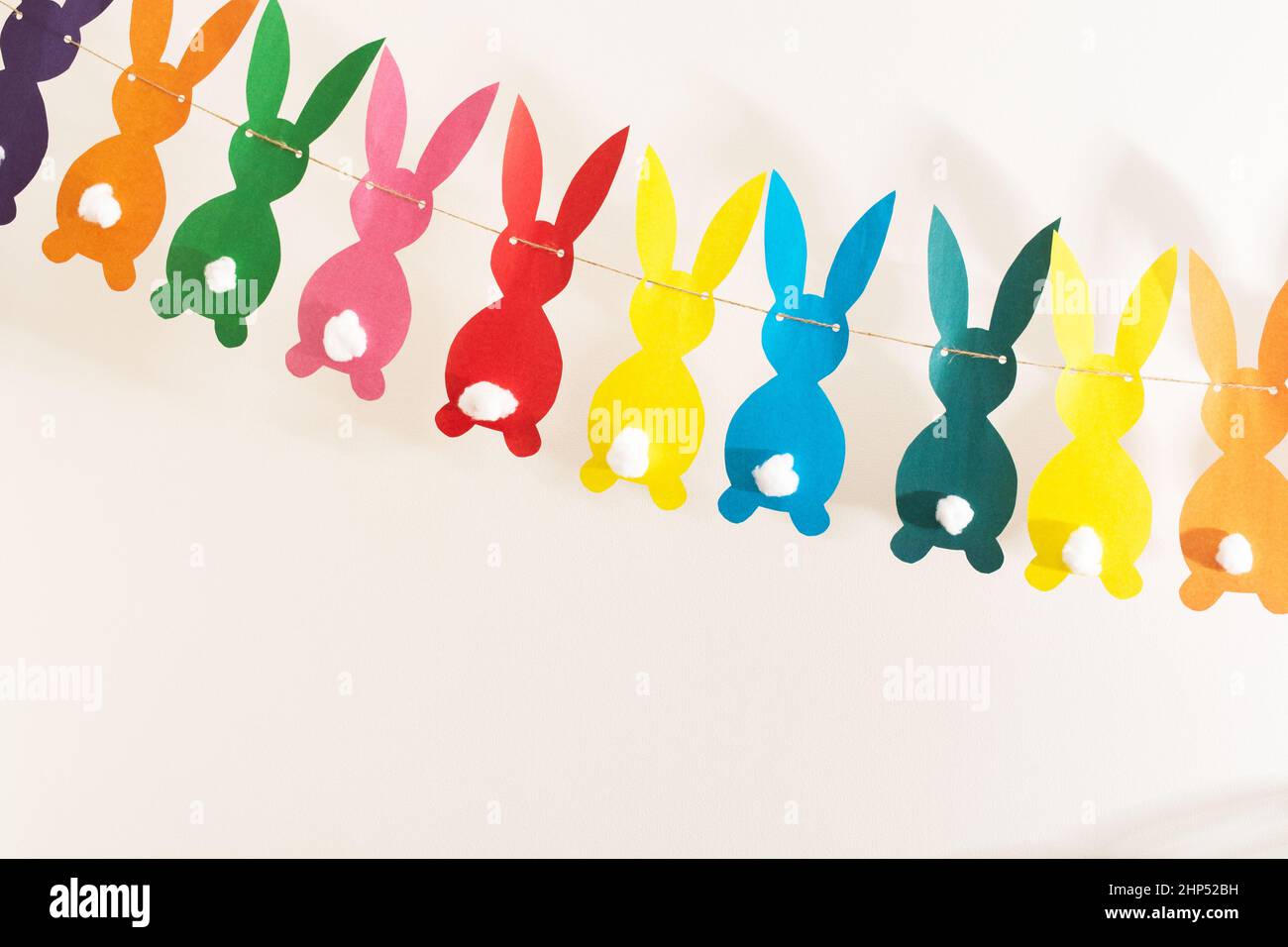 Handmade colorful paper garland with rabbits for Easter holiday Stock Photo