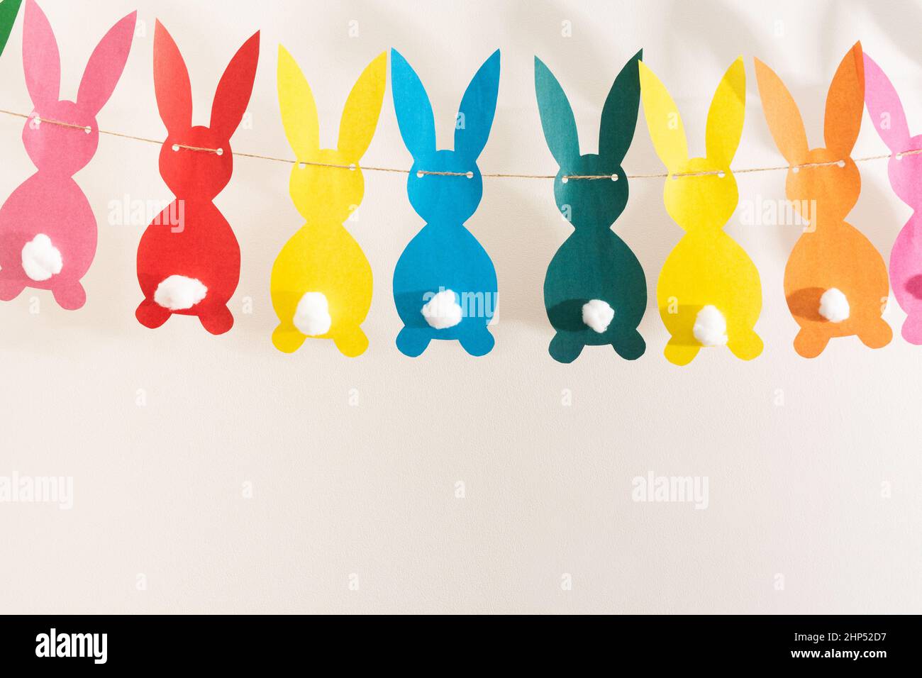 Handmade colorful paper garland with rabbits for Easter holiday Stock Photo