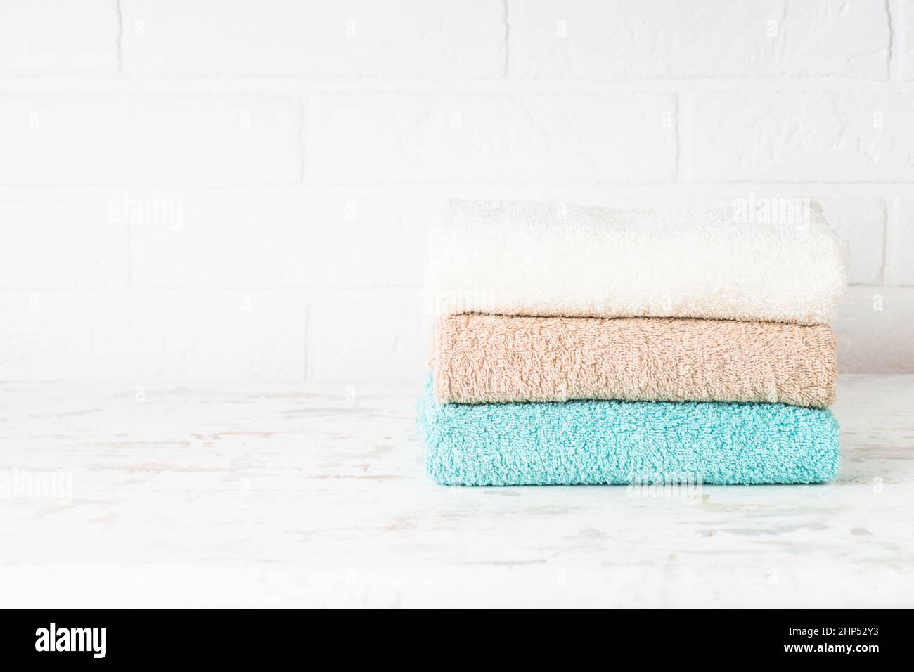 Stack of bath towels in white bathroom Stock Photo Alamy