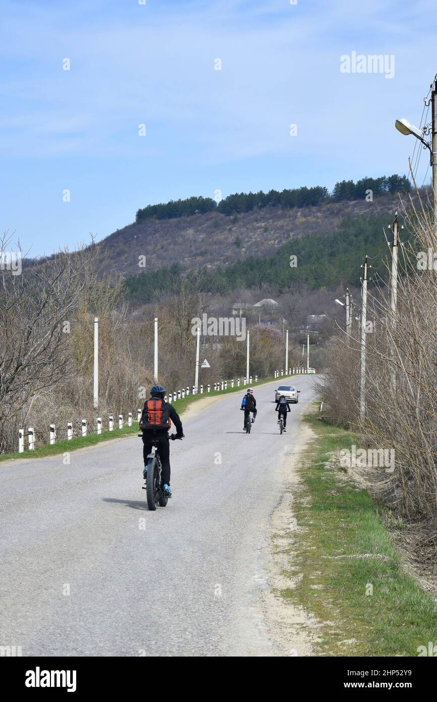 MOLDOVA, VILLAGE OF SARACEA - APRIL 7, 2019: Group of young cyclists ...