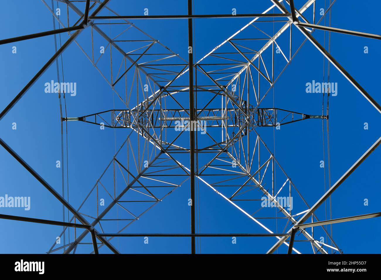 High voltage tower seen from underneath with blue sky Stock Photo - Alamy