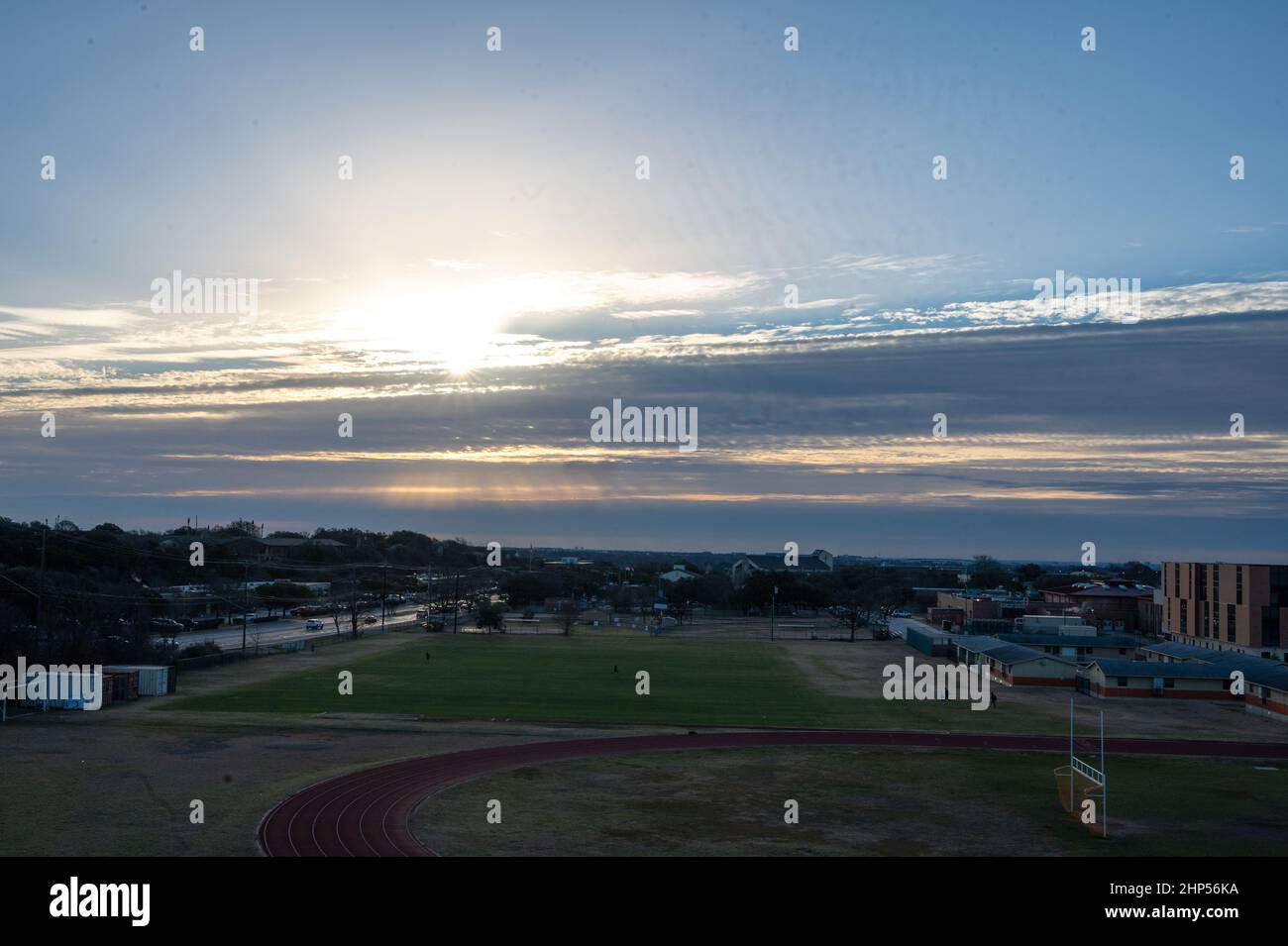 Austin, Texas, USA. 18 February, 2022. Runners on the track at Murchison Middle School. Austin wakes to freezing temperatures. Sunrise on Murchison Hill in Northwest Austin as people dressed for cold weather make their way to work. . Credit: Sidney Bruere/Alamy Live News Stock Photo