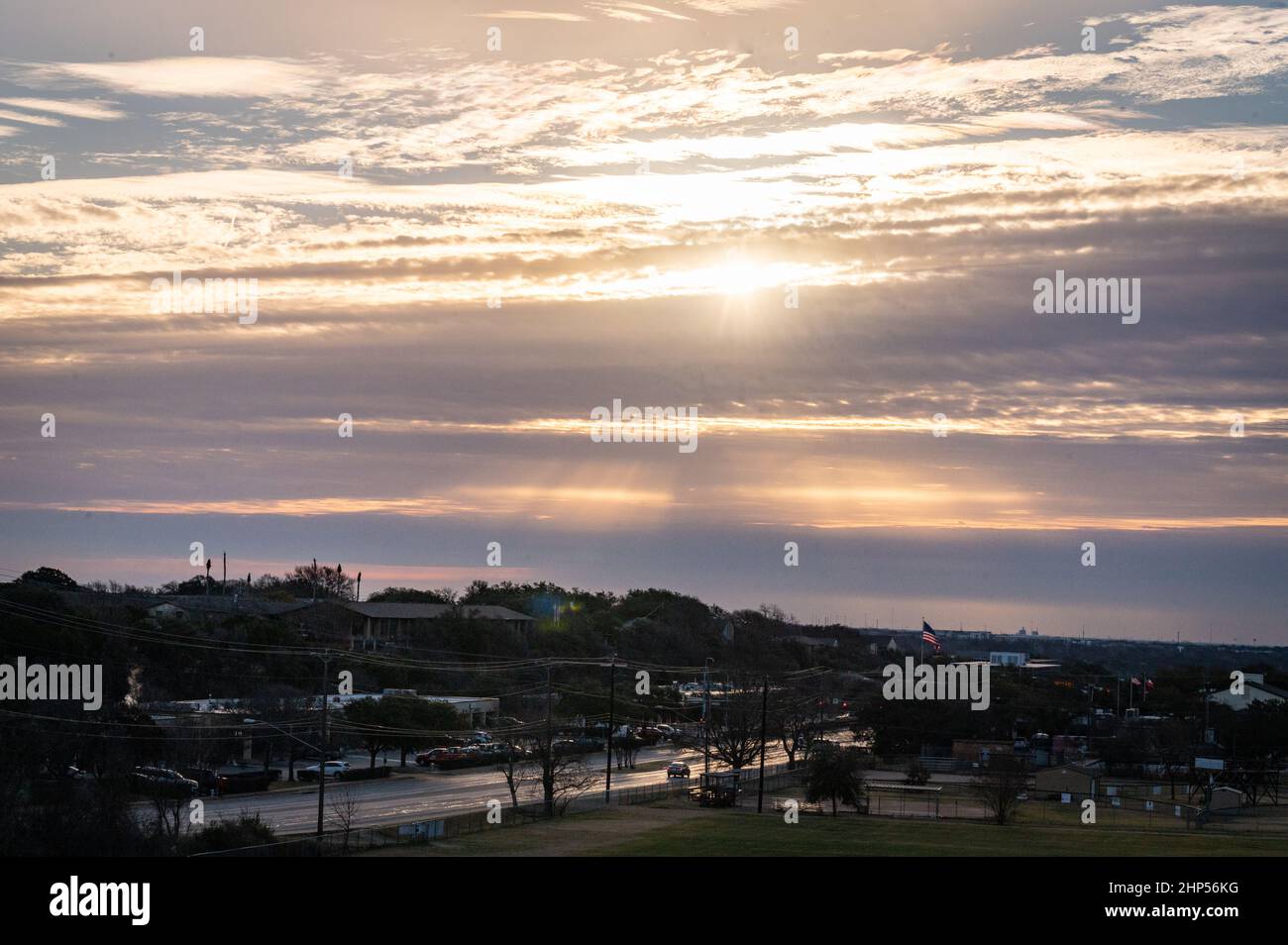 Austin, Texas, USA. 18 February, 2022. Austin wakes to freezing temperatures. Sunrise on Murchison Hill in Northwest Austin as people dressed for cold weather make their way to work. . Credit: Sidney Bruere/Alamy Live News Stock Photo