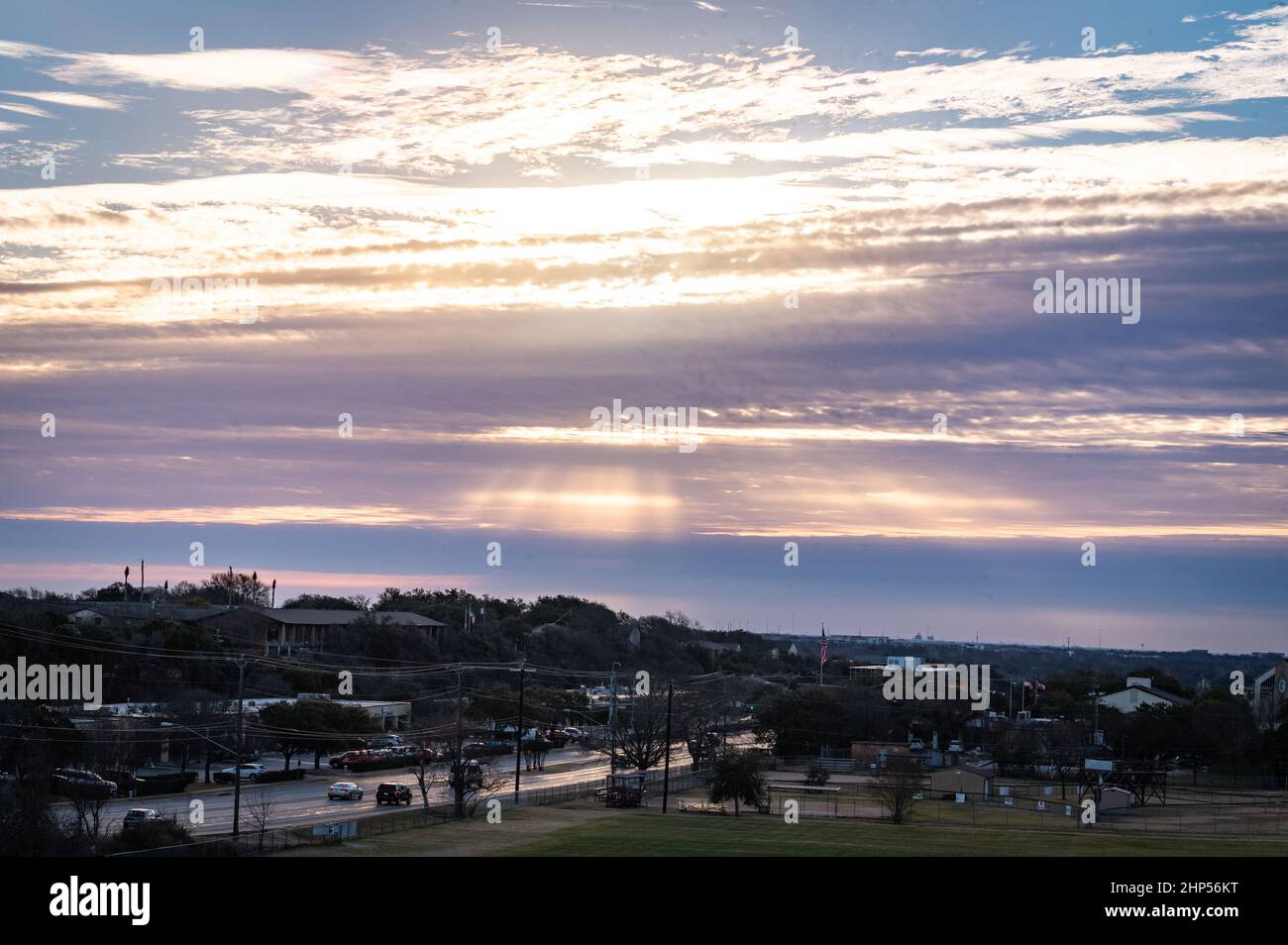 Austin, Texas, USA. 18 February, 2022. Austin wakes to freezing temperatures. Sunrise on Murchison Hill in Northwest Austin as people dressed for cold weather make their way to work. . Credit: Sidney Bruere/Alamy Live News Stock Photo