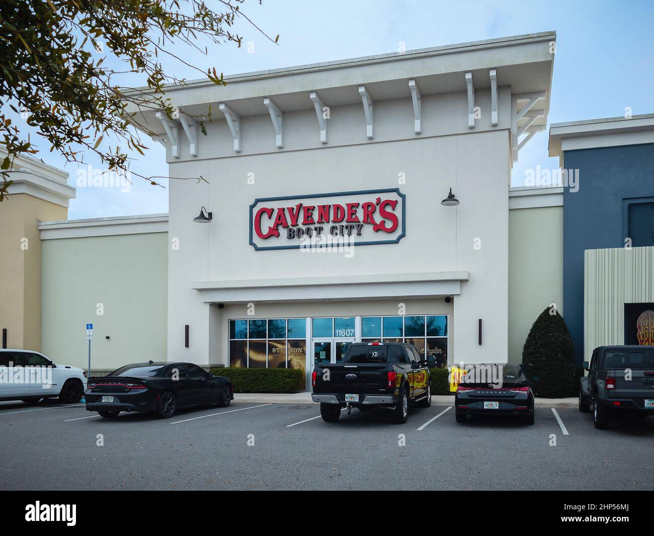 Orlando, Florida - February 5, 2022: Wide View of Cavender's Boot City Building Exterior and Parking Lot. Cavender's Western Wear Chain Store Founded Stock Photo