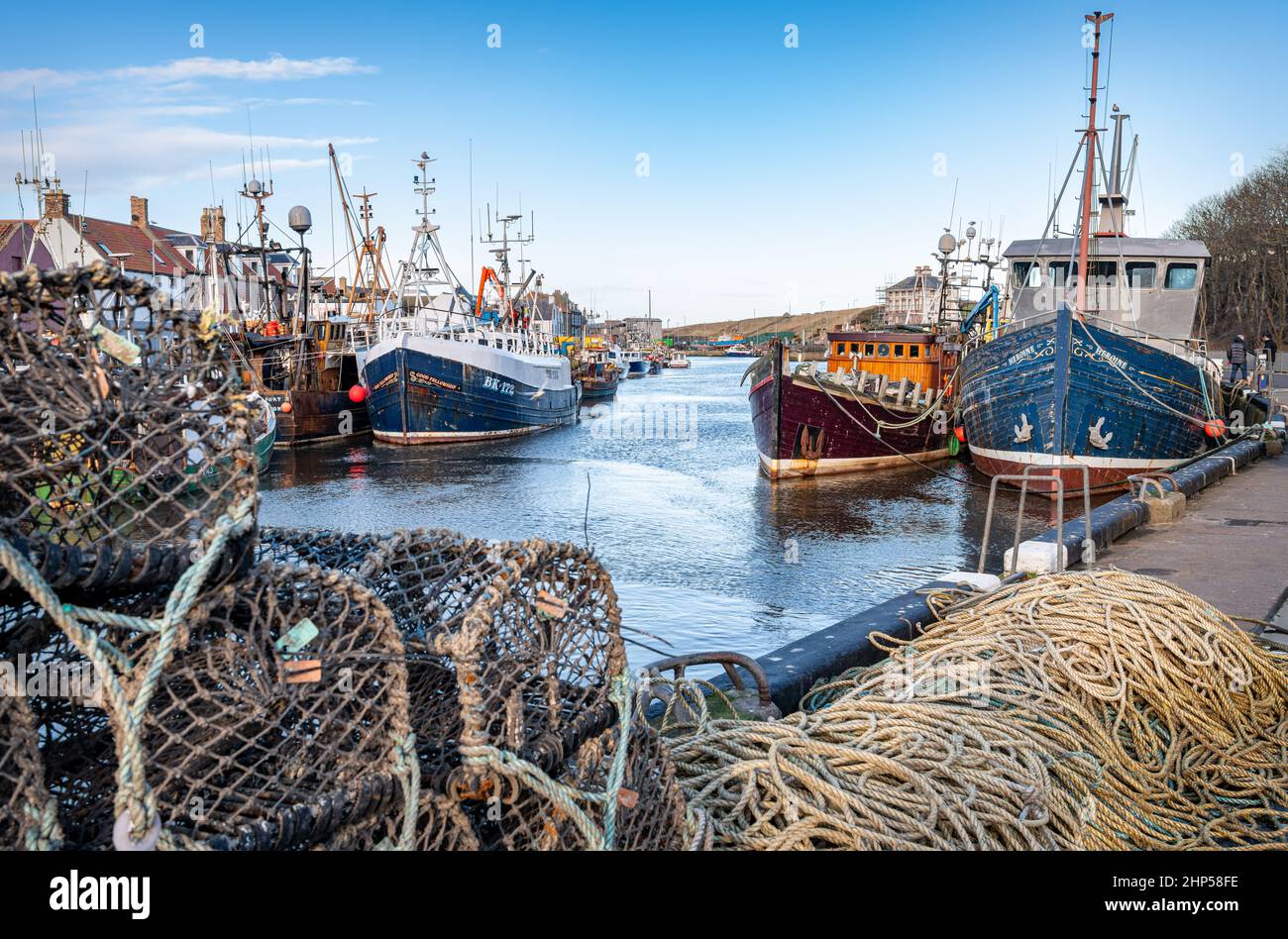 Fishing boats and trawlers docked beside lobster pots in Eyemouth