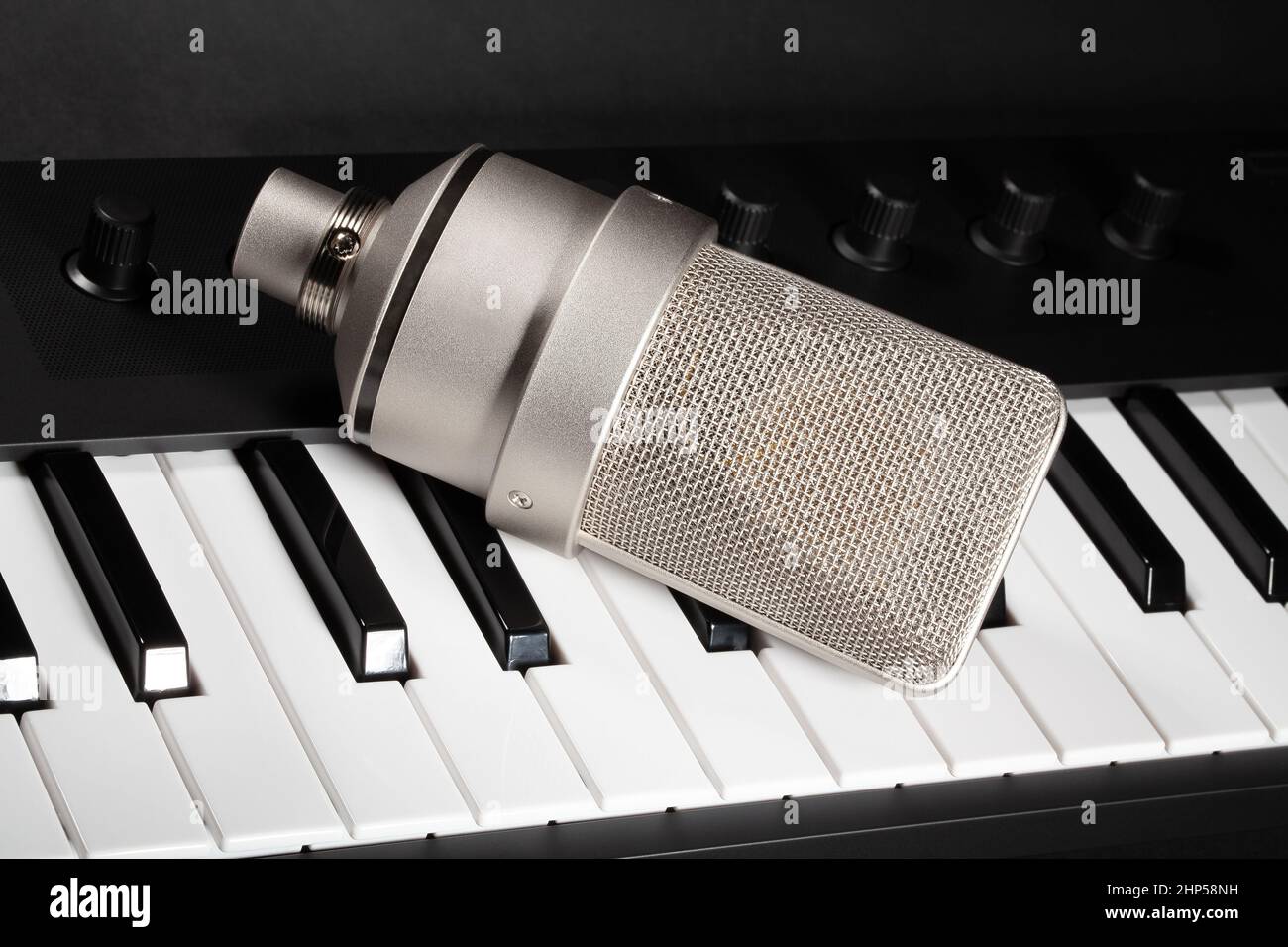 condenser microphone on keyboard background Stock Photo