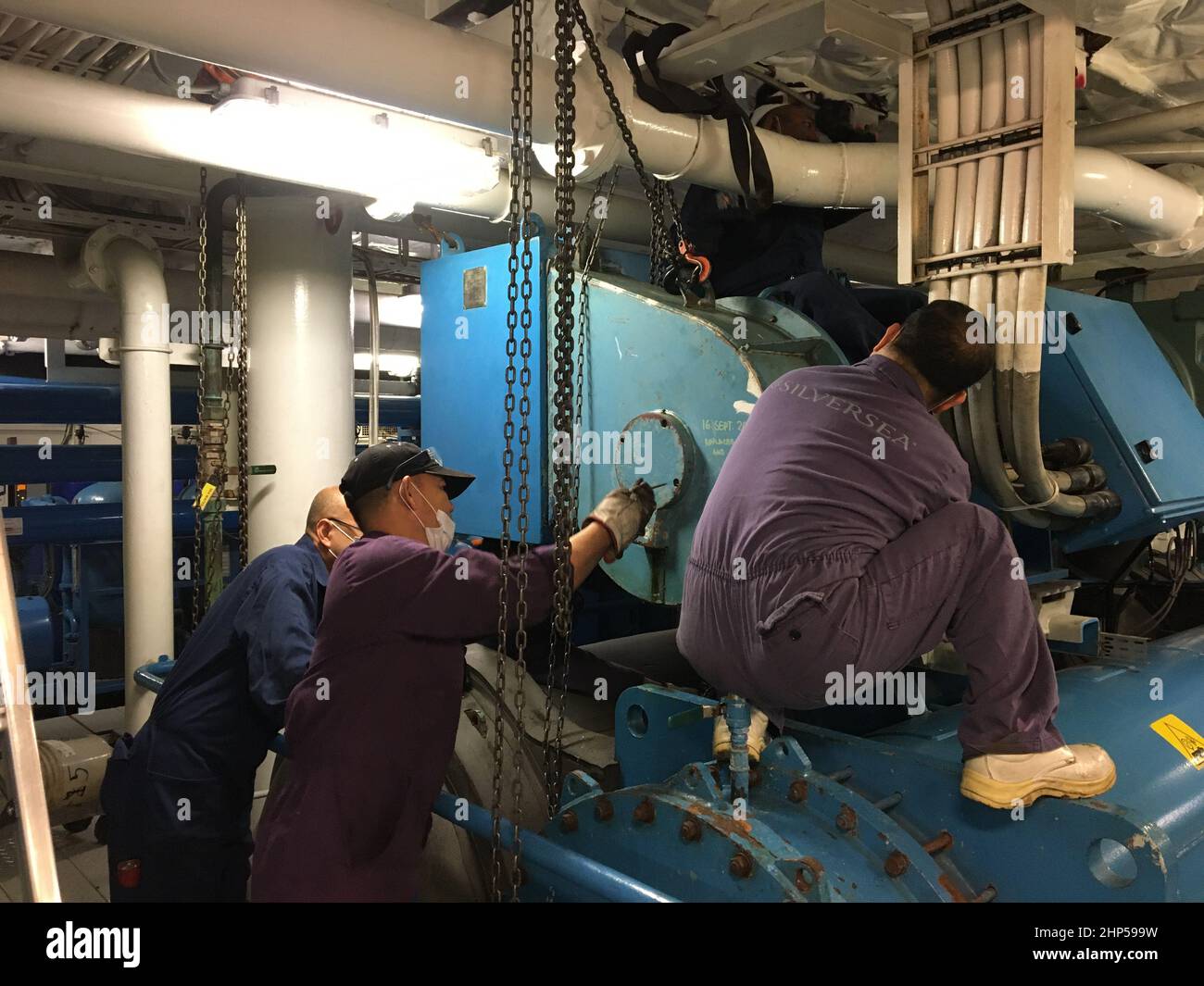 ships crew doing electrical motor repair,bearing replacement of