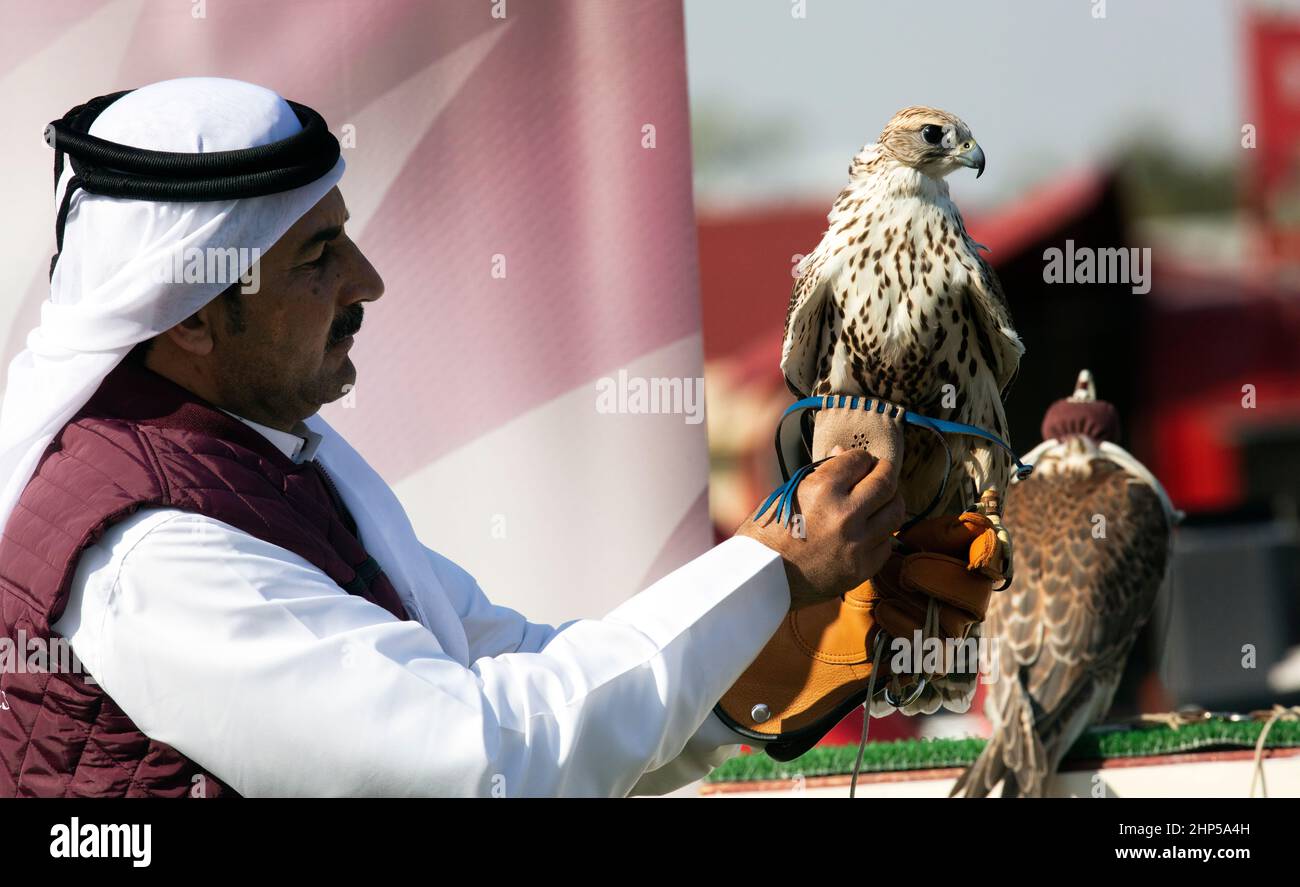 A falcon trainer in the Falcon market Doha Qatar 18022022 Stock Photo
