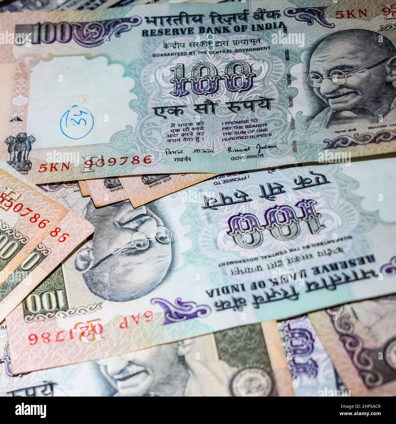 Old One Hundred Rupee notes combined on the table, India money on the rotating table. Old Indian Currency notes on a rotating table, Indian Currency o Stock Photo