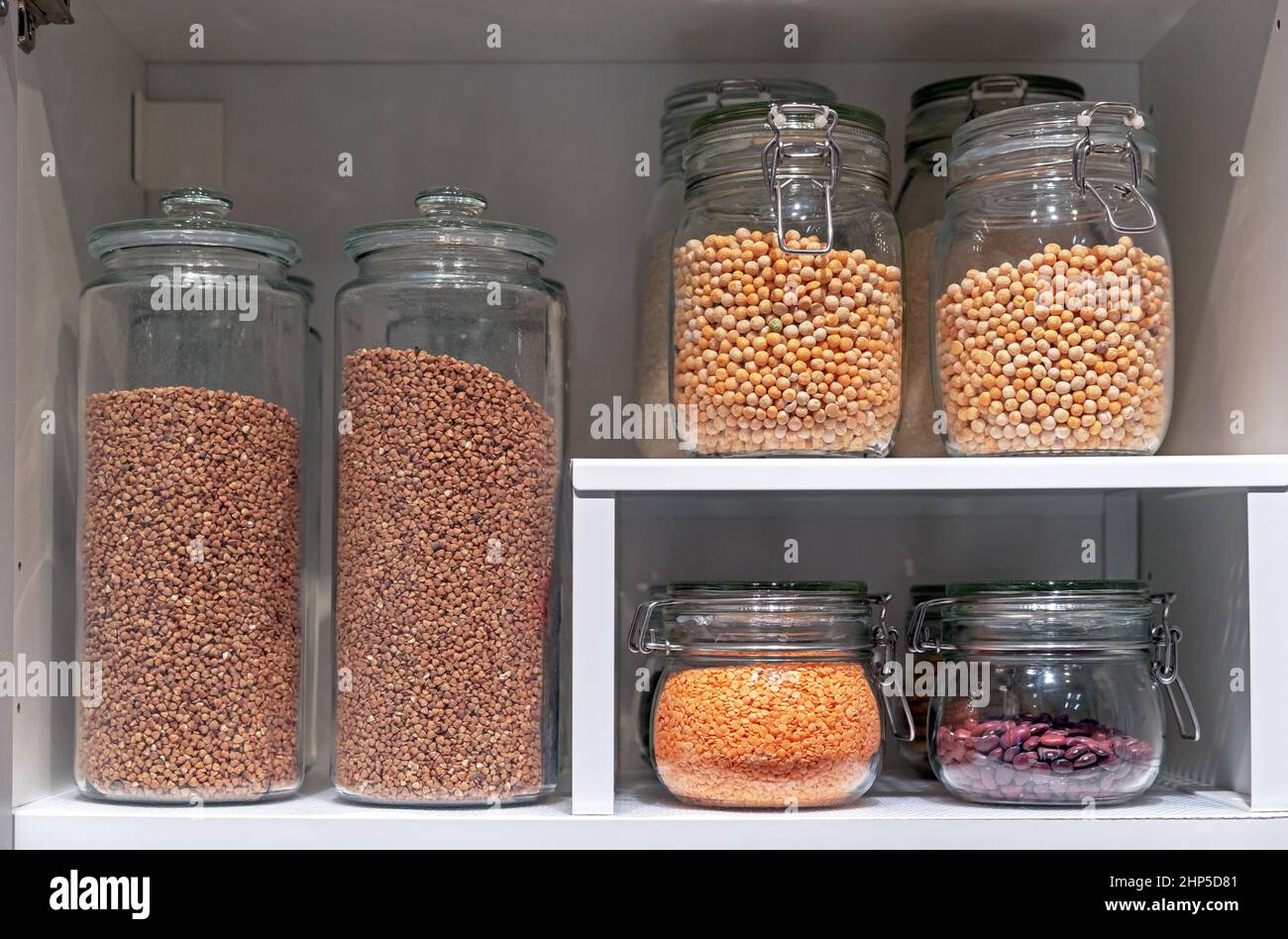 Glass jars with various cereals and grains. Foods storage concept Stock