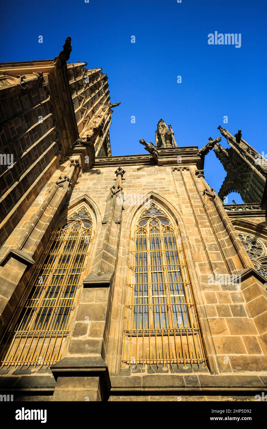 Detail of facade and windows of St Vitus, Wenceslas and Adalbert Cathedral at Prague Castle, showing flying buttresses and gargoyles Stock Photo