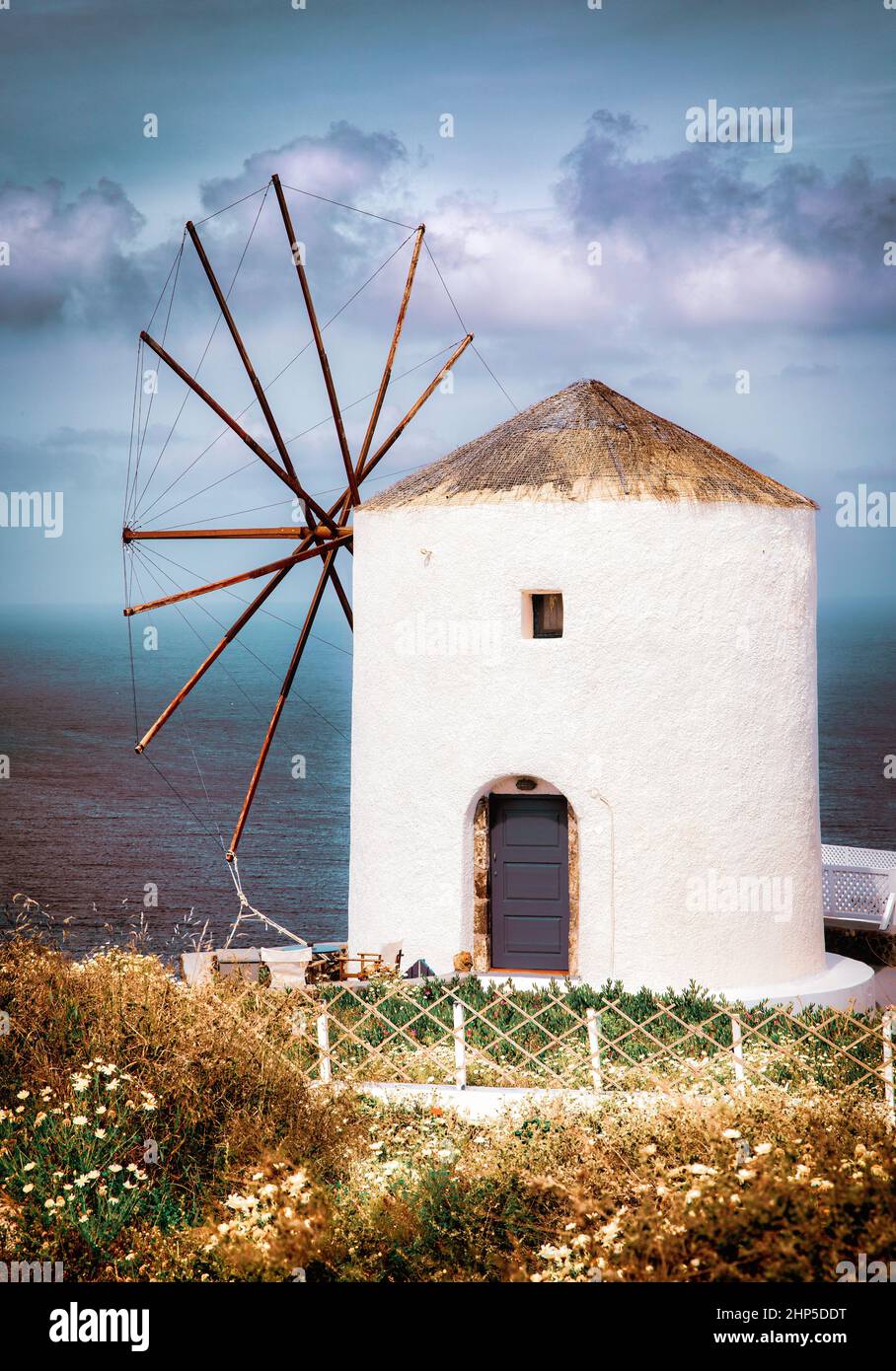 An intact windmill in the village of Oia on Santorini, Greece. Stock Photo