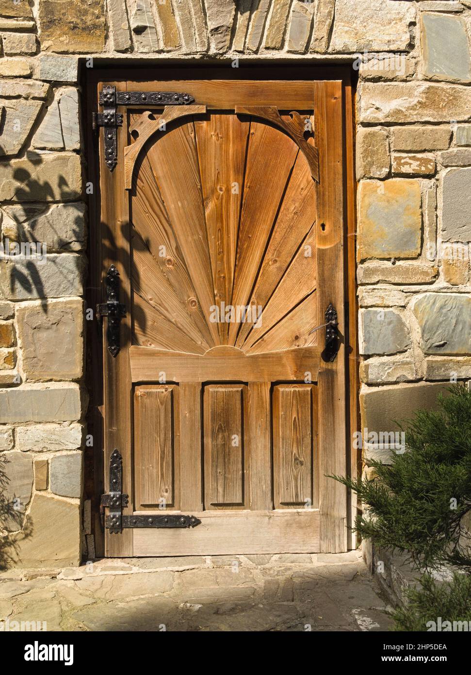 wooden doors, stone walls, plant shadows, handmade work Stock Photo