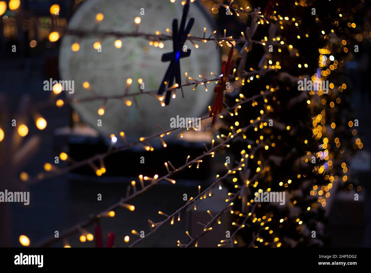 New Year's garlands. Lights in street. Decoration of city. Blurry background of LED garlands. Stock Photo