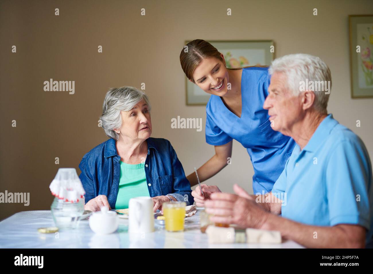 Hows breakfast. Shot of two residents and a nurse at a retirement home. Stock Photo