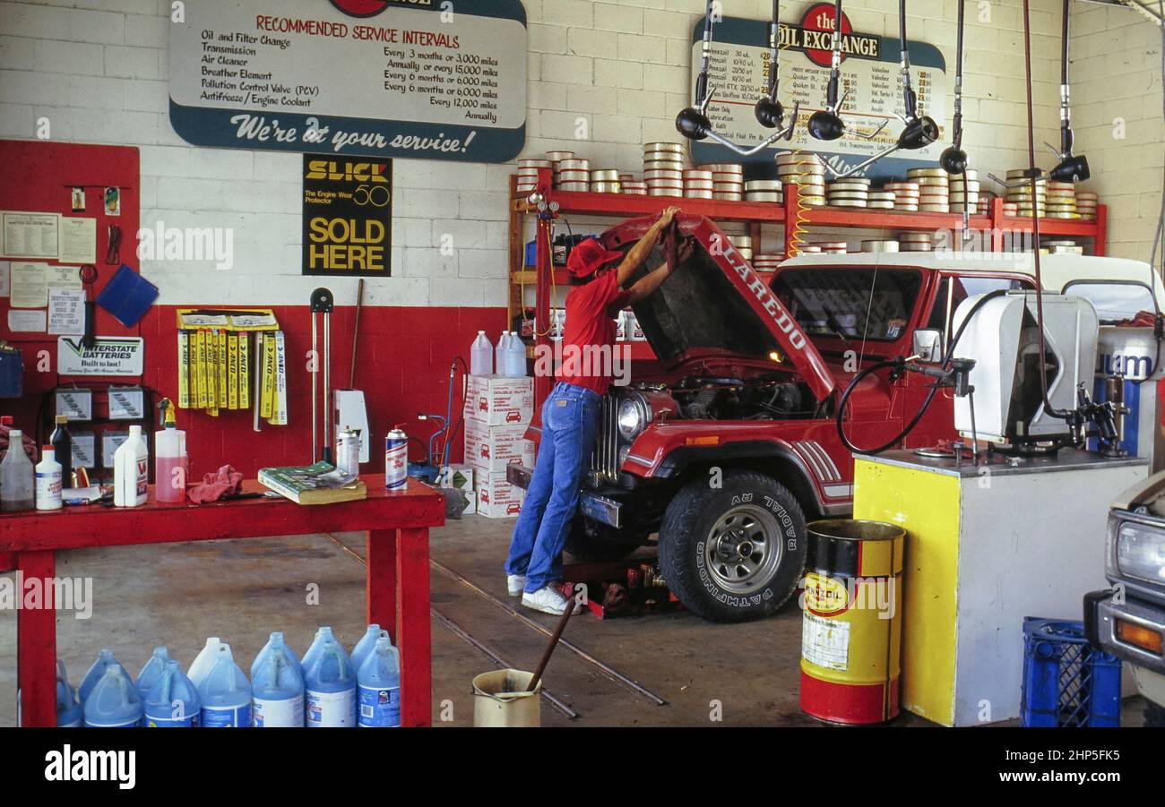 A row of hose reels hanging from the ceiling of an automotive repair shop  Stock Photo - Alamy