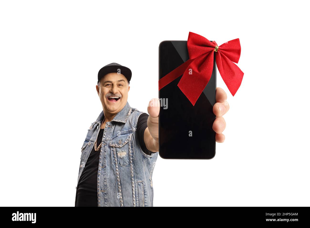 Mature man in a denim vest holding a smartphone with a red ribbon isolated on white background Stock Photo