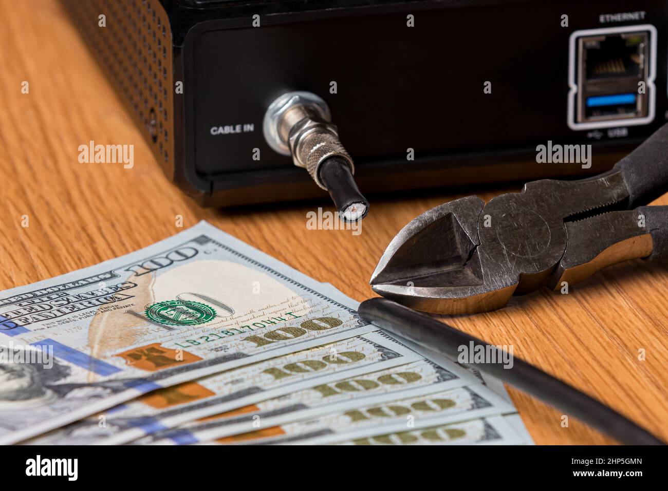 Cable TV cord being cut with cash money. Cord cutting, wireless