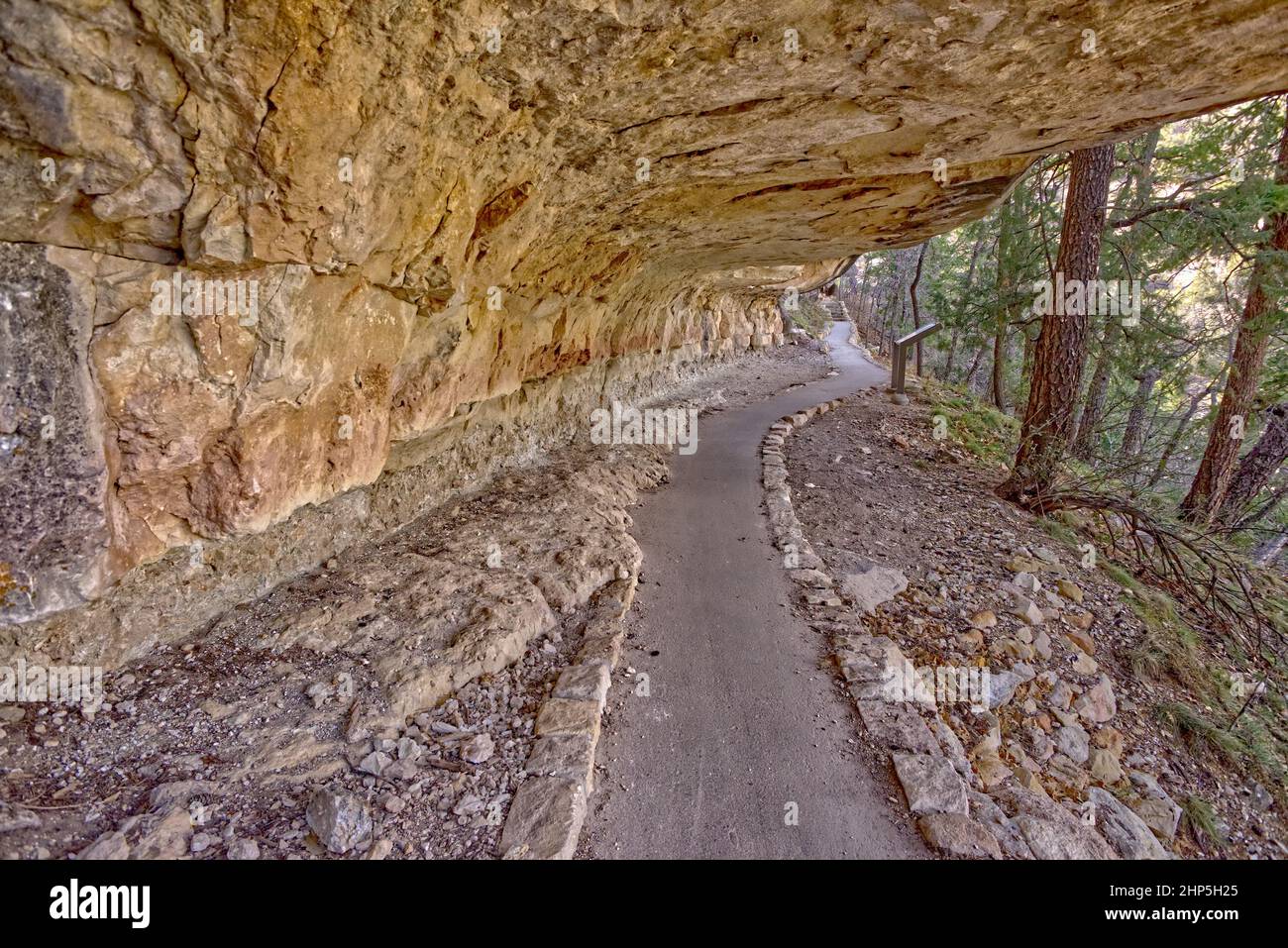 Walk into History. The Sky Island Trail at Walnut Canyon National Monument leading under an overhang of sandstone. The canyon is managed by the Nation Stock Photo