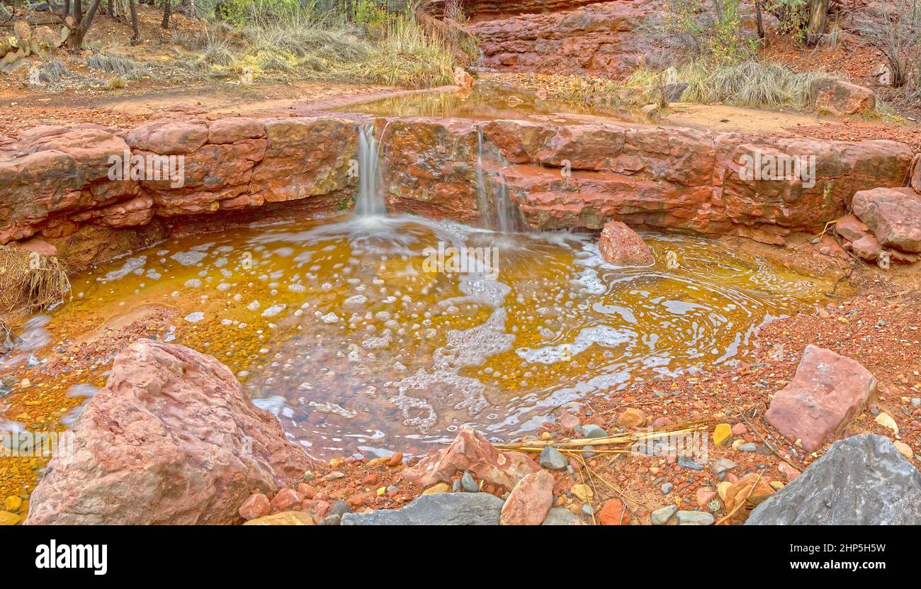 Soapy Pool in Wilson Canyon Sedona. A pool of water being fed by a small waterfall creating a soapy foam. Stock Photo