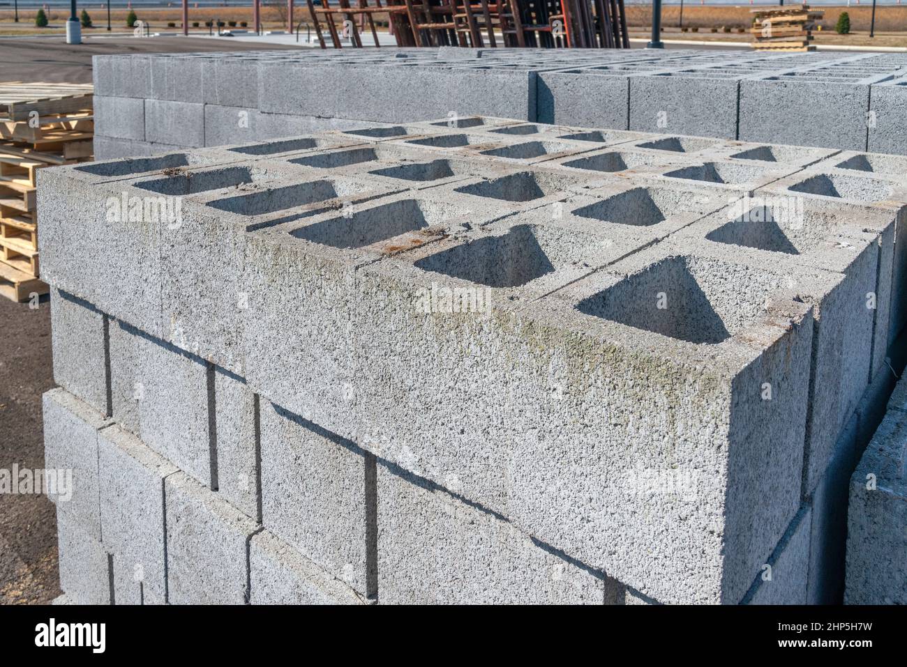 Horizontal shot of stacks of cinder blocks and other building materials at a construction site. Stock Photo