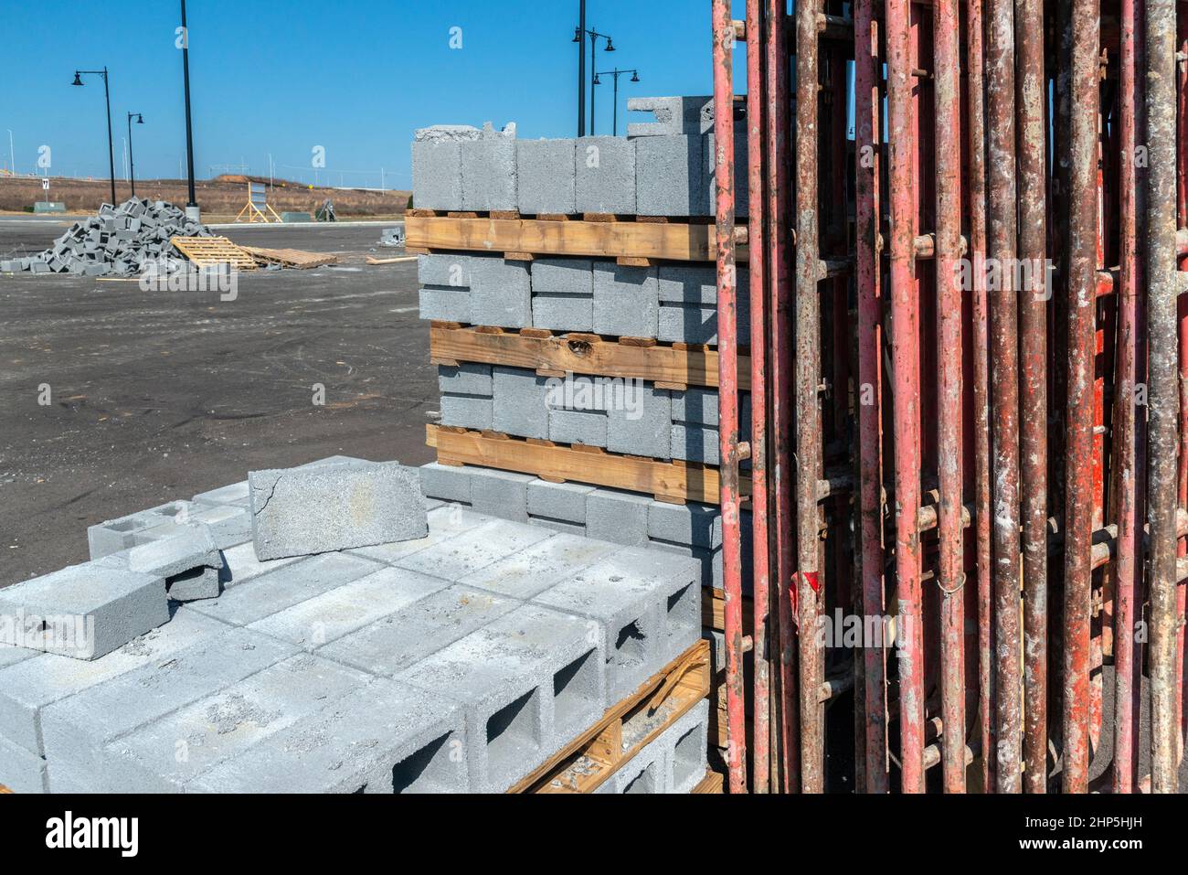 Horizontal shot of new cinder blocks and scaffolding at a new construction site location. Stock Photo
