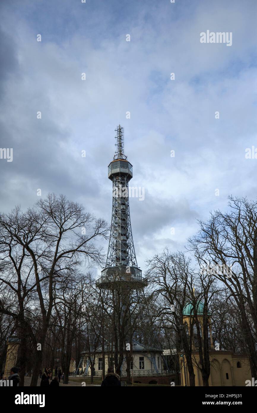 Petrin Lookout Tower from the ground rising above Petrin park in winter with bare trees Prague, Czech Republic Stock Photo