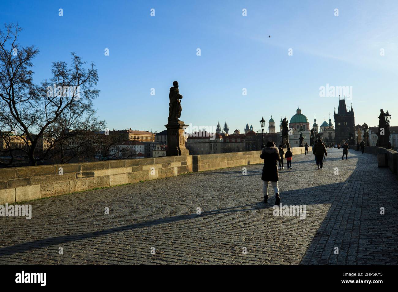 Tourists on the Charles Bridge, in late afternoon sunshine, Prague, Czech Republic Stock Photo