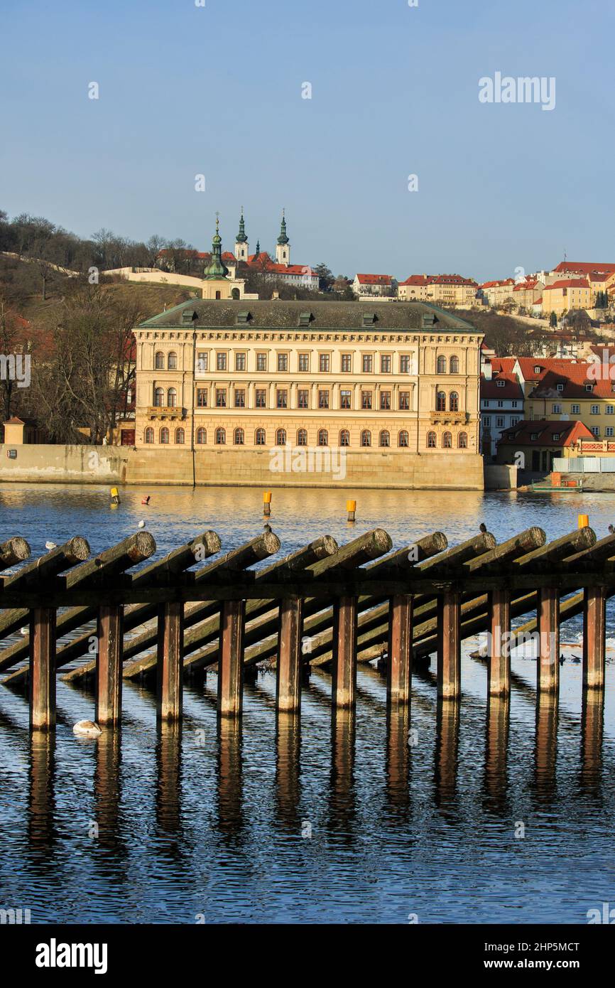 Liechtenstein Palace, Petrin Hill and Strahov Monastery across the wooden breakwater, River Vltava, from Smetana Embankment, Prague, Czech Republic Stock Photo