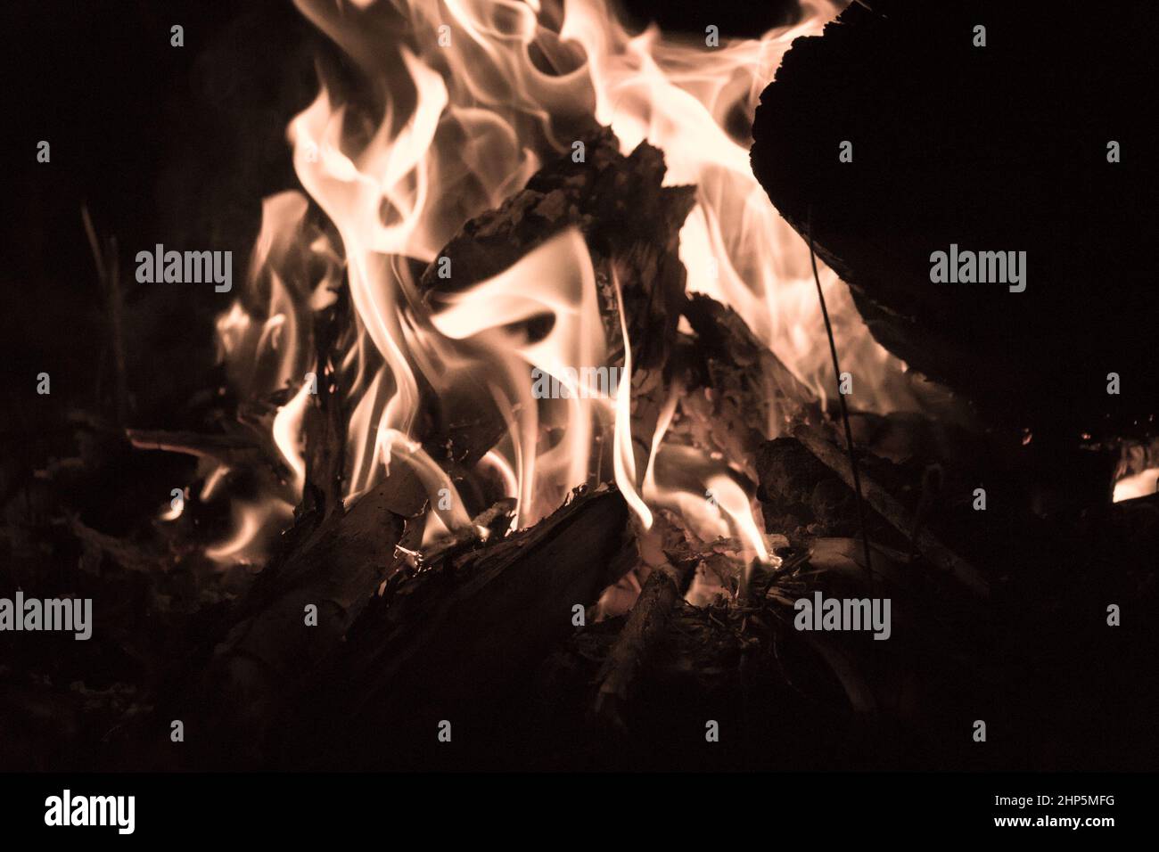 The view of bright flames and fire blazing at night on black background ...