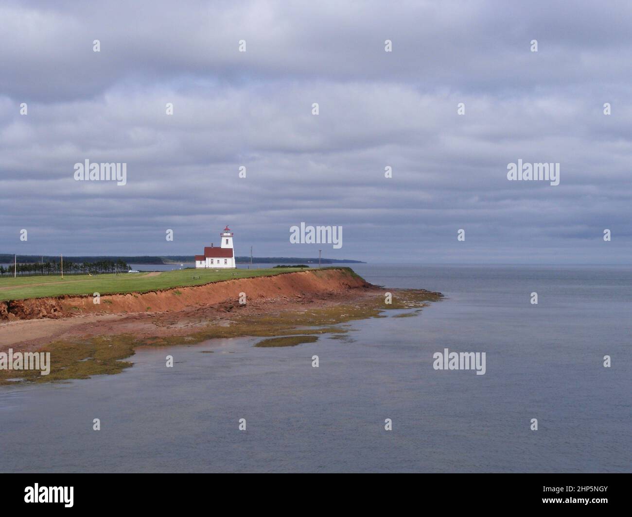 Wood Islands Lighthouse along red cliffs of Prince Edward Island Stock
