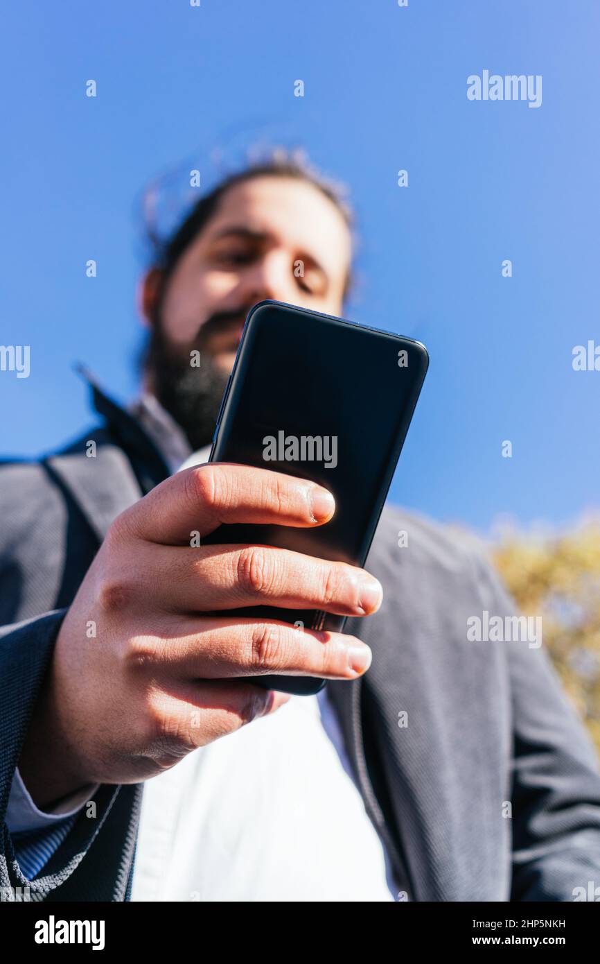 young business man looking phone near to office Stock Photo