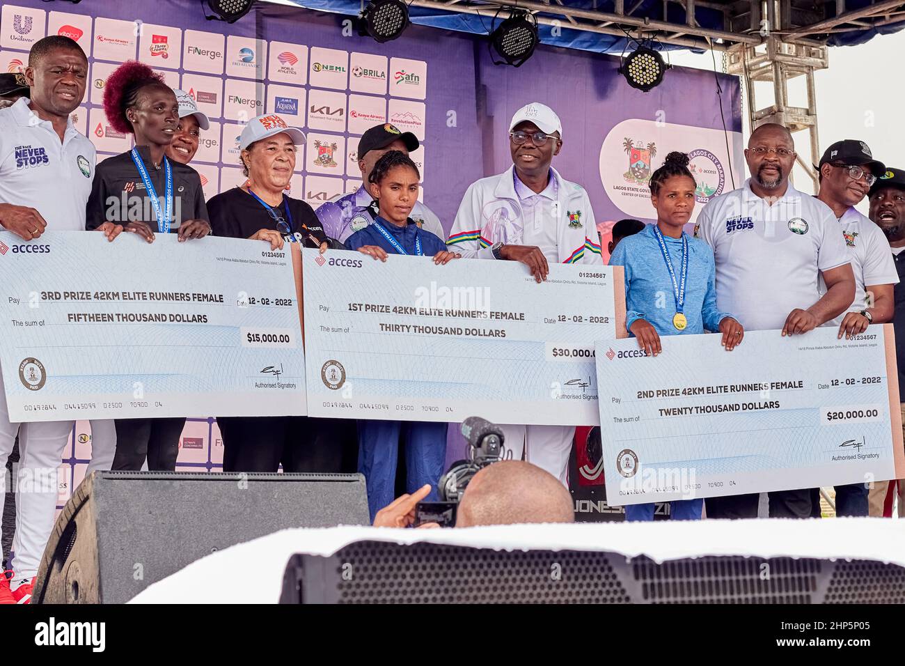 Female marathon winners are pictured with their medal and prize money